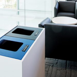 a commercial recycling & waste station in a waiting area with sofas in the background