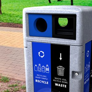 an outdoor recycling station by walkway in park