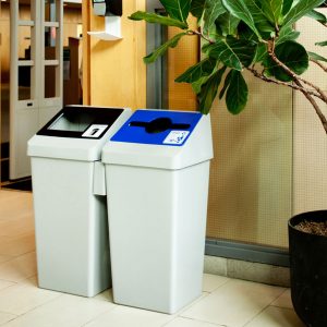 two smart sort indoor recycling bins in a hallway